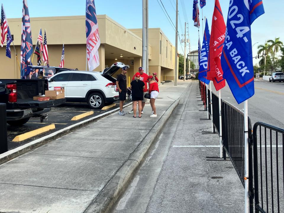 People gather to greet former President Trump's SUV as he pulls in to the underground garage of the federal courthouse in Fort Pierce, Florida, on March 14, 2024.