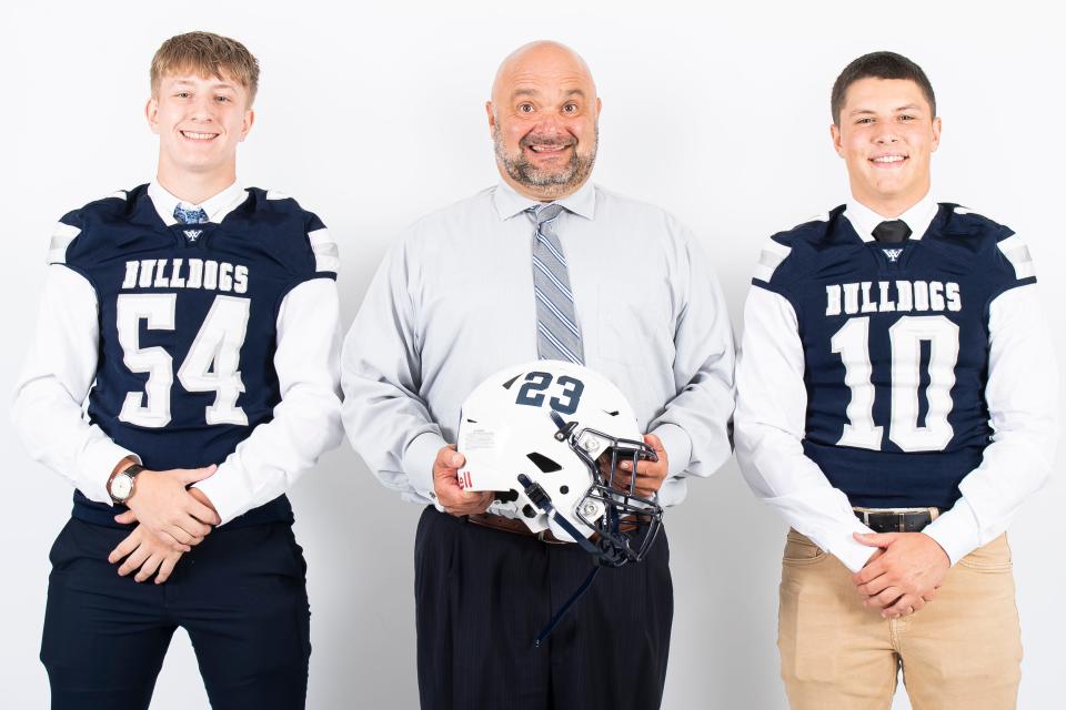 West York football players William Baker (54) and Kyan Moore (10) pose for a photo with head coach Ron Miller during YAIAA football media day on Tuesday, August 1, 2023, in York. 