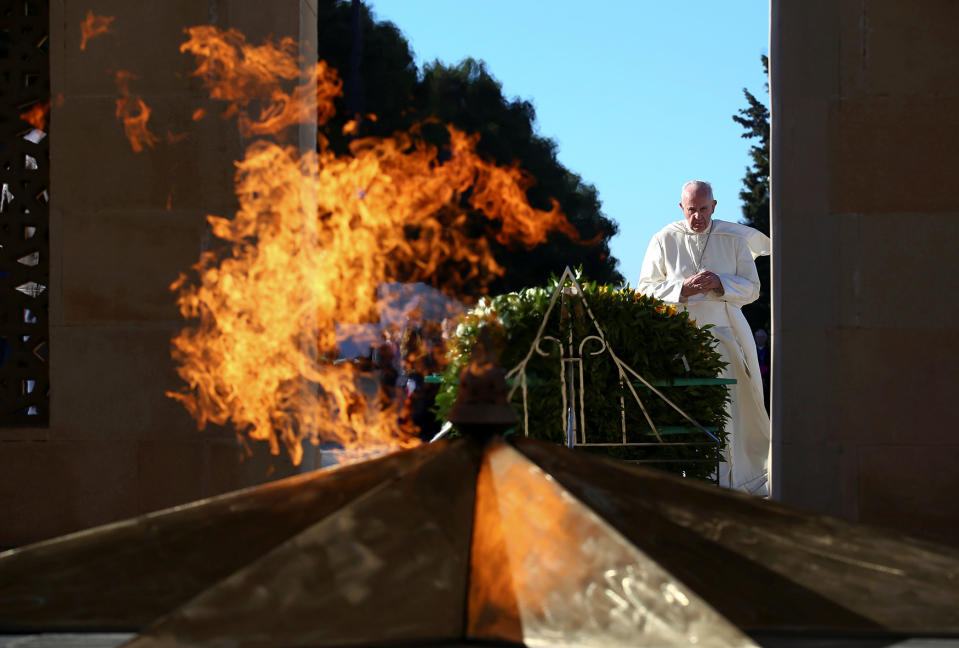 Pope Francis prays in front of the monument to the fallen in Ganjlik