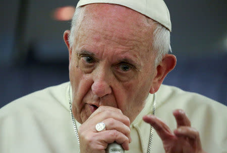 FILE PHOTO: Pope Francis gestures during a news conference on board of the plane during his flight back from a trip to Chile and Peru, January 22, 2018. REUTERS/Alessandro Bianchi/File Photo