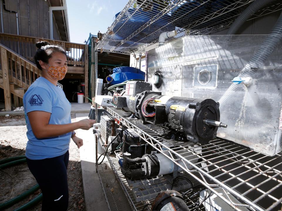 Lindsey Chang, environmental technician at the Marine Science Center, shows equipment destroyed by the effects of Tropical Storm Ian, Friday, Oct. 21, 2022.