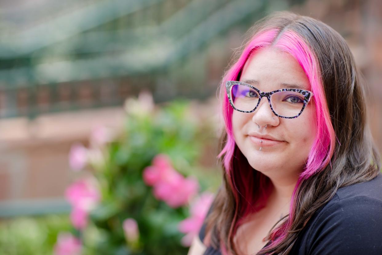 Shaelyn Nielsen sits for a photo in a healing garden in Omaha, Thursday, Aug. 3, 2023. Nielsen says she was sexually abused by a house parent while she was a resident at Boys Town.