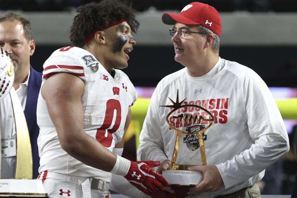 FILE - Wisconsin running back Braelon Allen (0) and Wisconsin head coach Paul Chryst confer after defeating Arizona State in the Las Vegas Bowl NCAA college football game Thursday, Dec. 30, 2021, in Las Vegas. After playing in five of the first seven Big Ten championship games, the Badgers have made it to Indianapolis just once in the last four years. They blew a chance to get there in 2021 by losing at Minnesota in their regular-season finale. (AP Photo/L.E. Baskow, File)