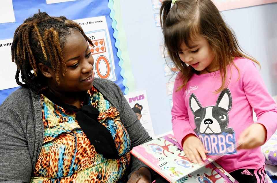 Chirjuamn Washington reads to Veda Joshi at the Arc Caddo-Bossier Goldman School at The Highland Center Wednesday morning, February 7, 2024.