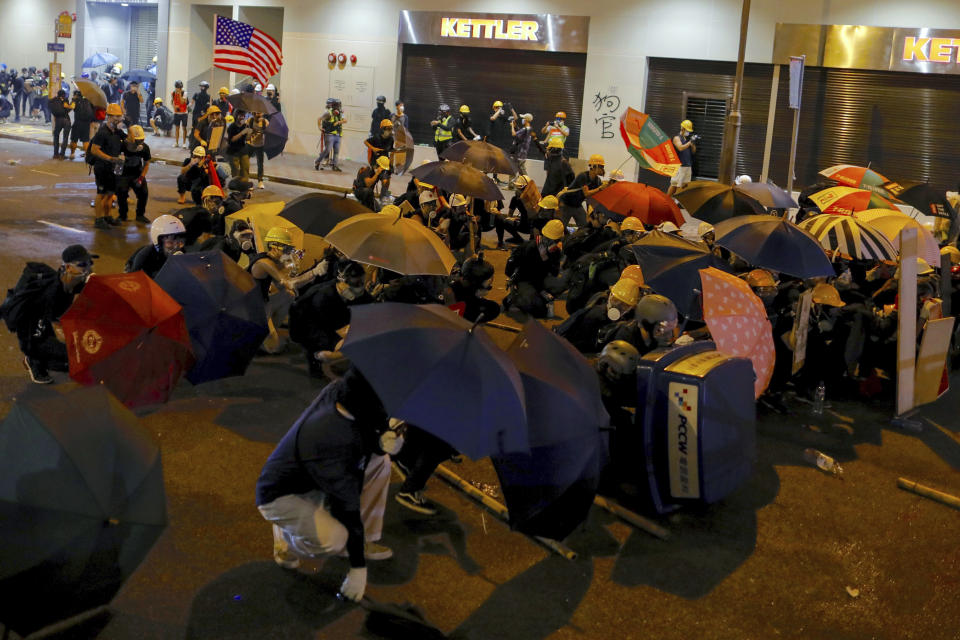 Protesters use umbrellas to shield themselves from tear gas during a protest in Hong Kong, Sunday, July 28, 2019. Police fired tear gas at protesters in Hong Kong on Sunday for the second night in a row in another escalation of weeks-long pro-democracy protests in the semi-autonomous Chinese territory. (AP Photo/Vincent Yu)