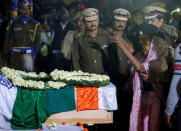 Bonomala Santra, mother of Bablu Santra, a Central Reserve Police Force (CRPF) personnel who was killed after a suicide bomber rammed a car into the bus carrying CRPF personnel in south Kashmir on Thursday, wails next to a coffin containing the remains of her son at Bauria village in Howrah district in the eastern state of West Bengal, India, February 16, 2019. REUTERS/Rupak De Chowdhuri