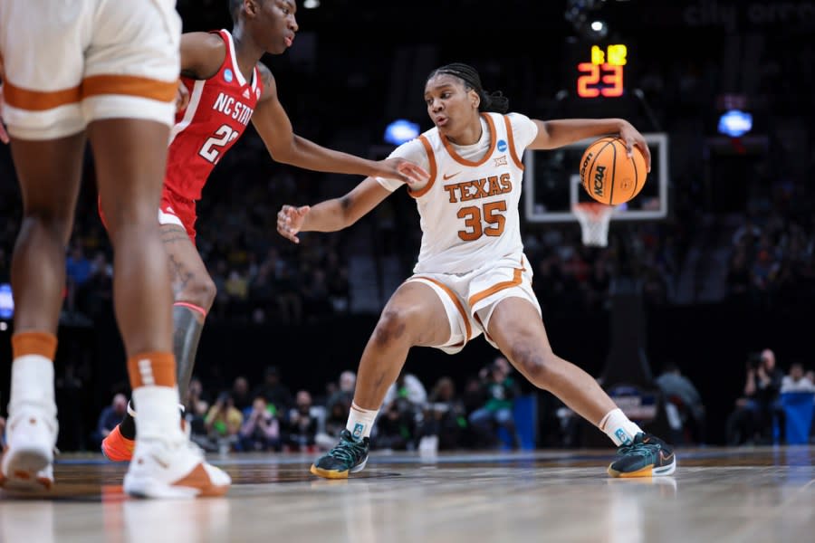 Texas forward Madison Booker (35) tries to get around North Carolina State guard Saniya Rivers during the first half of an Elite Eight college basketball game in the women’s NCAA Tournament, Sunday, March 31, 2024, in Portland, Ore. (AP Photo/Howard Lao)