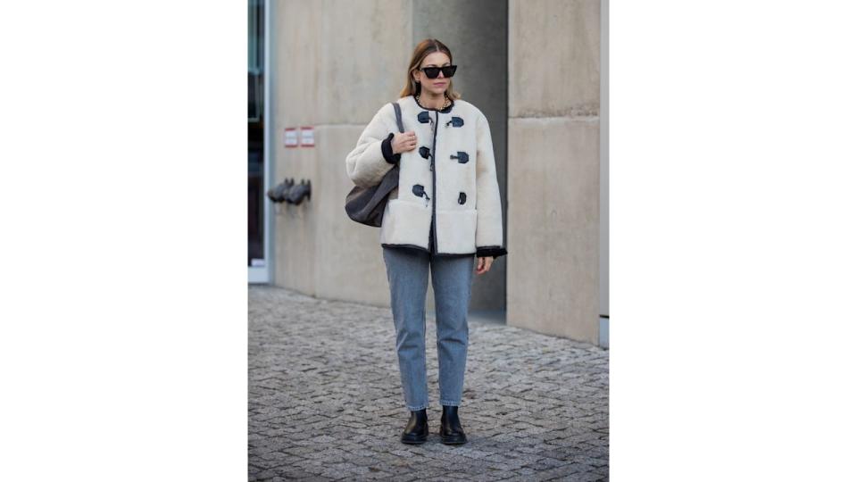 Duffle coat and jeans on model