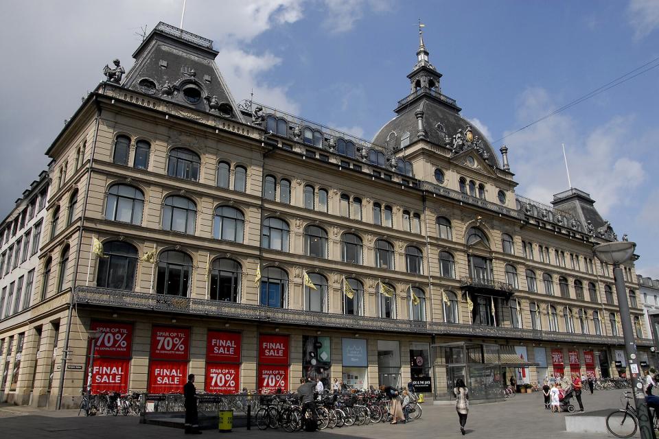 Shoppers walk by windows at Magasin du nord department store