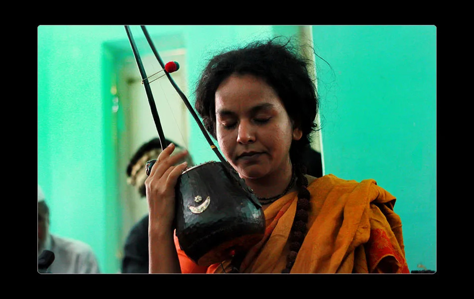 <b>PARVATHY BAUL</b> Magic happened in the informal session on the sixth afternoon in the dhuni of Jageri. Parvathy was singing to us of surrender. And I saw surrender happen in action – Parvathy surrendered to the song; all of us to her singing. Faces changed expression; something dropped. She urged the mind (mann) to return to its nija niketana (its proper abode). Minds quietened. Silence after the song, within the song. ... Parvathy spoke of how music descends into the very cells of the body in a state of surrender, how the body is able to receive it with a quietness of mind...