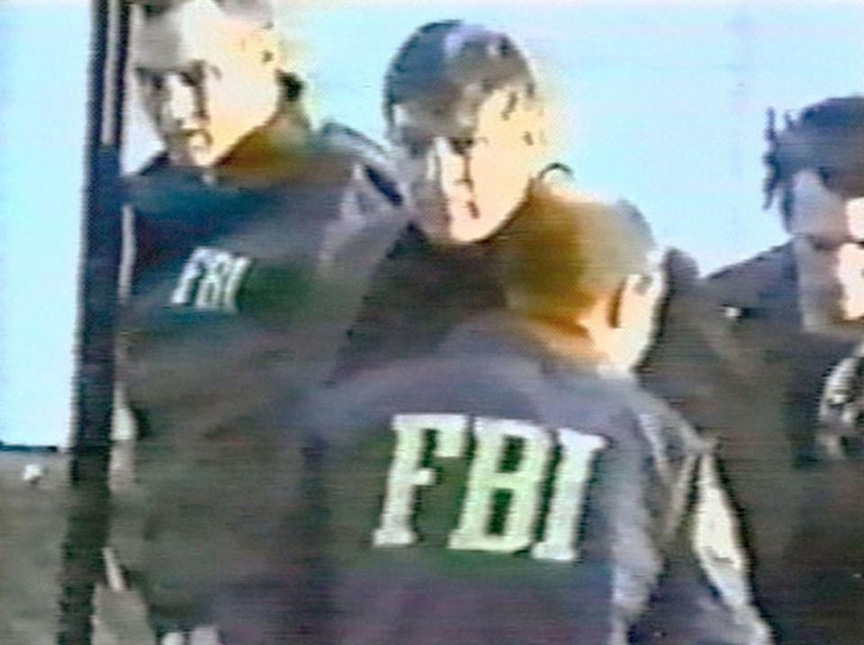 <div class="inline-image__caption"><p>FBI agents arrest counterintelligence agent Robert Hanssen (C) near his home February 18, 2001 in Vienna, Virginia. According to the FBI, Hanssen had just placed a package of classified material in a park he had been using since 1985 to exchange documents with Russian spies. Hanssen is currently serving a prison sentence of life without parole. </p></div> <div class="inline-image__credit">Getty</div>