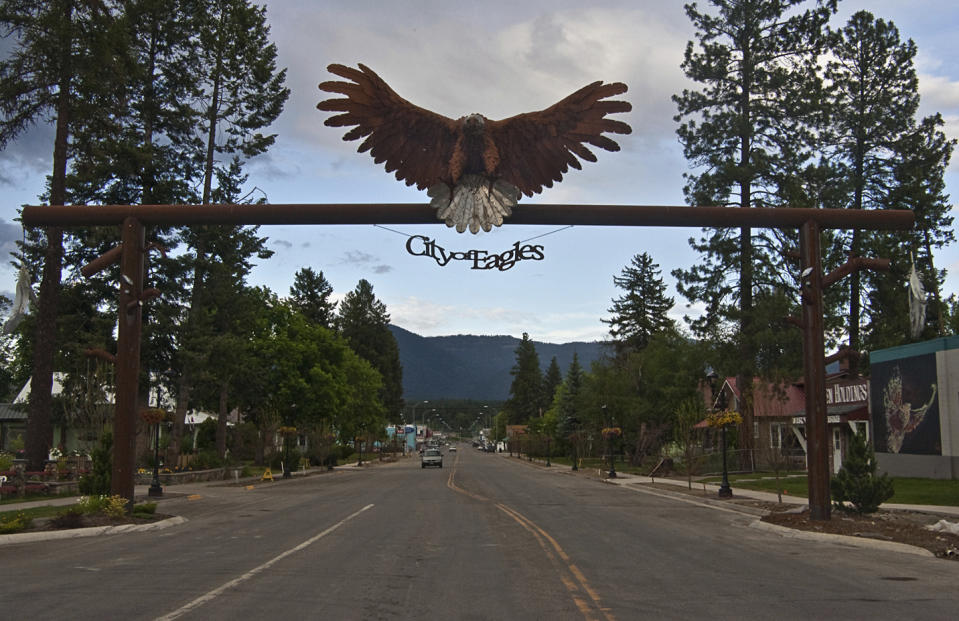 FILE - An eagle sign welcomes visitors at the entrance to downtown Libby, Mont., June 17, 2009. On July 18, 2023, a judge ruled that a health clinic in Libby is liable to the government for almost $6 million in penalties and damages after submitting hundreds of false asbestos claims. (AP Photo/Rick Sheremeta, File)