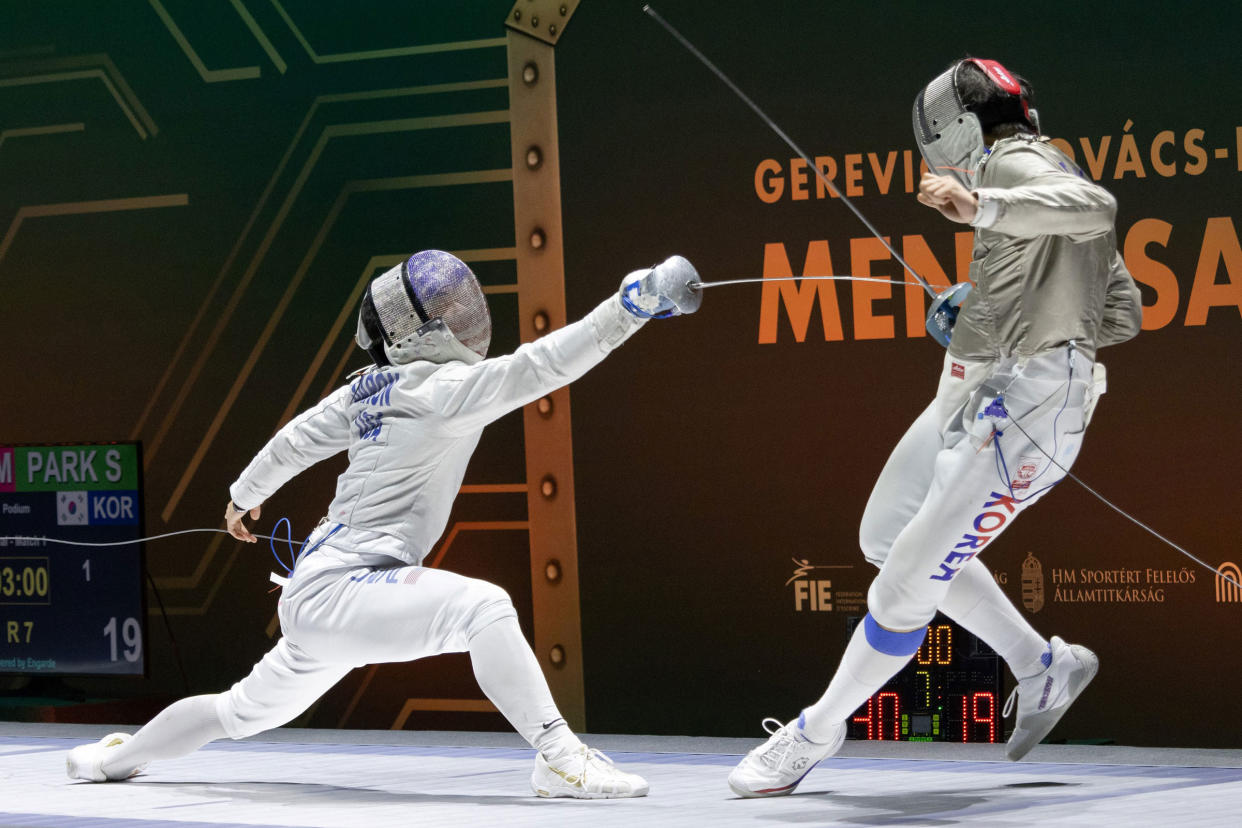 Mitchell Saron, left, and Park Sangwon compete during the team final at the Men's Sabre World Cup in Budapest, Hungary, on March 24, 2024.<span class="copyright">Attila Volgyi—Xinhua/Getty Images</span>