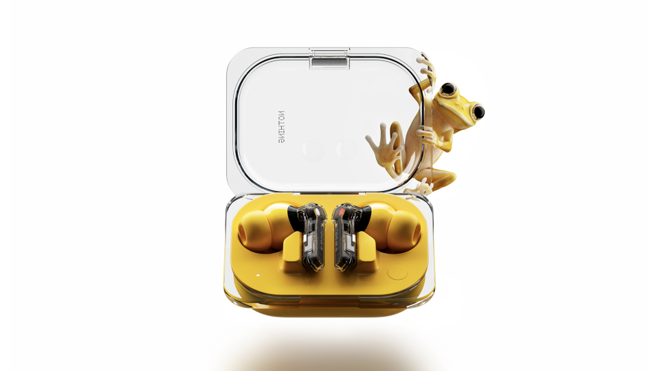 Nothing Ear (a) earbuds in their case, with a frog inexplicably climbing the case