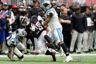 Carolina Panthers outside linebacker Shaq Thompson, right and Carolina Panthers cornerback A.J. Bouye (24) hit Atlanta Falcons running back Mike Davis (28) during the second half of an NFL football game, Sunday, Oct. 31, 2021, in Atlanta. (AP Photo/Mark Humphrey)