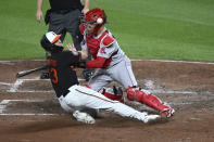 Baltimore Orioles' Kyle Stowers, left, is safe at the plate as Boston Red Sox catcher Reese McGuire loses the ball during the third inning of a baseball game Friday, Aug. 19, 2022, in Baltimore. (AP Photo/Gail Burton)