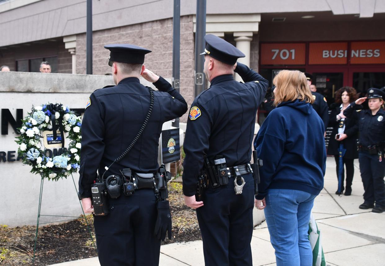 Lebanon City Police Chief Bret Fisher and Lora Lebo participate in a wreath laying memorial ceremony for Lt. William Lebo outside city hall on March 28, 2024.