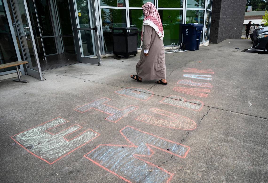 Imam Abdulhakim Mohammed walks over a chalk drawing that was created for a celebration of the Islamic holiday, Eid al-Adha, at what will soon be the new Islamic Center on Montana Avenue in Tacoma, on Saturday, July 9, 2022.