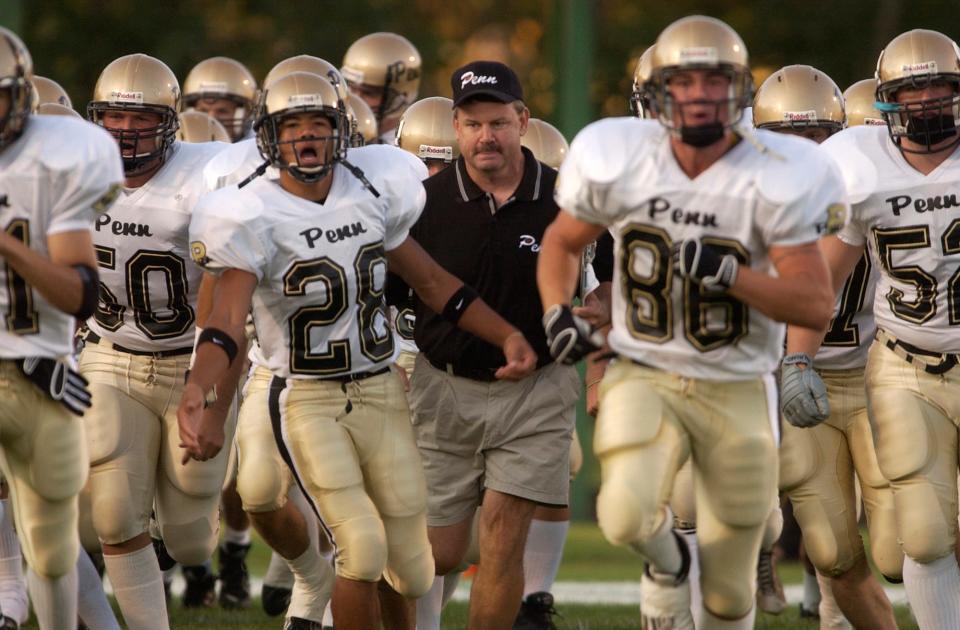 Penn Head Coach Cory Yeoman heads into the field with his team at Valparaiso in this 2003 South Bend Tribune file photo.