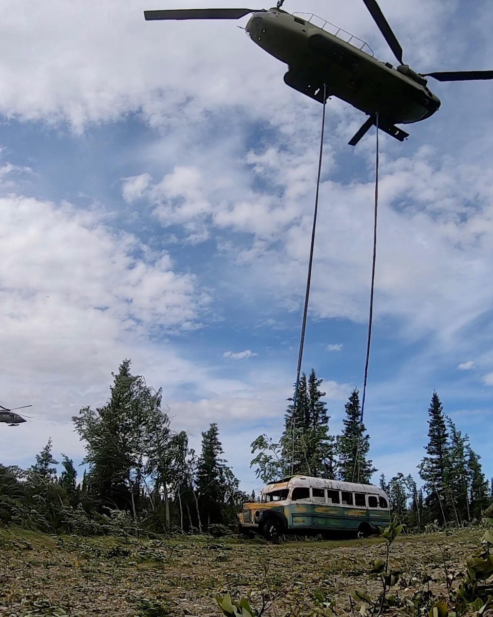 In this photo released by the Alaska National Guard, Alaska Army National Guard soldiers use a CH-47 Chinook helicopter to removed an abandoned bus, popularized by the book and movie "Into the Wild," out of its location in the Alaska backcountry Thursday, June 18, 2020, as part of a training mission. Alaska Natural Resources Commissioner Corri Feige, in a release, said the bus will be kept in a secure location while her department weighs various options for what to do with it. (Sgt. Seth LaCount/Alaska National Guard via AP)
