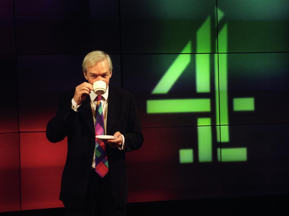 British newscaster Jon Snow drinks a cup of tea during a break during the Channel 4 news.