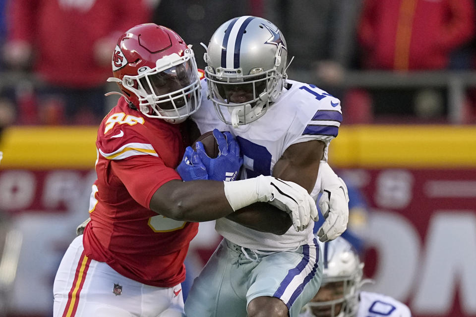 Dallas Cowboys wide receiver Michael Gallup, right, is stopped by Kansas City Chiefs defensive tackle Tershawn Wharton, left, during the first half of an NFL football game Sunday, Nov. 21, 2021, in Kansas City, Mo. (AP Photo/Charlie Riedel)