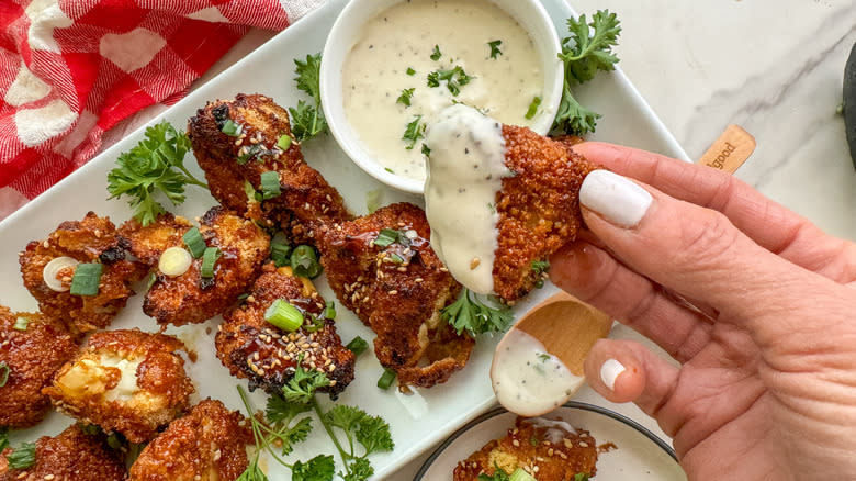 cauliflower wing dipped in sauce