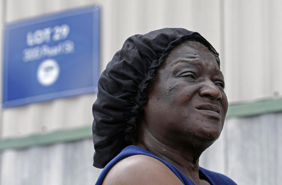 In this photo taken Wednesday, May 29, 2019 mobile home resident Shirley Pittman is interviewed outside her home on Pearl Street at a Time Out community in Lumberton, N.C. Pittman was surprised when she got a new lease lease from Time Out Communities in February to pay a higher lot rental price of $465 a month. Mobile home residents in Robeson County, North Carolina are seeing increasing rent prices after being slammed by hurricanes Matthew and Florence.(AP Photo/Gerry Broome)