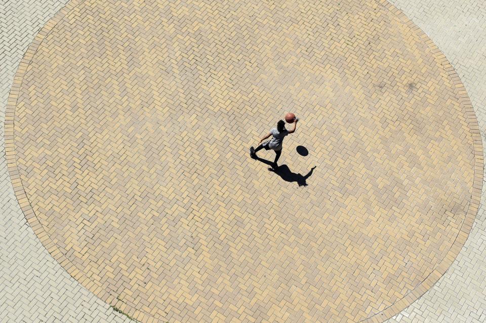 LOUISVILLE, KENTUCKY - March 29: A child dribbles a basketball at Waterfront Park. Out of the concern of COVID-19 all of the city's playgrounds are closed until May. (Photo by Andy Lyons/Getty Images)