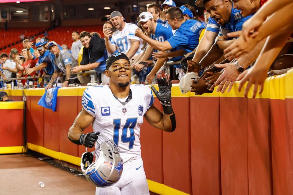 Detroit Lions wide receiver Amon-Ra St. Brown (14) high fives fans after 21-20 win over Kansas City Chiefs at Arrowhead Stadium in Kansas City, Mo. on Thursday, Sept. 7, 2023.