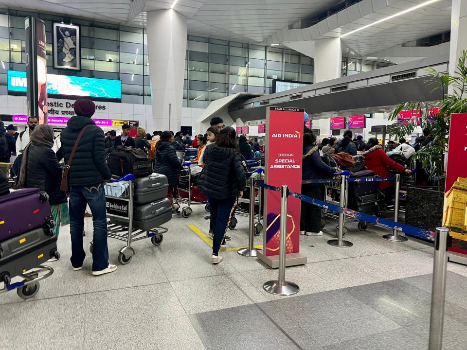 Dozens of people crowding the check-in area.