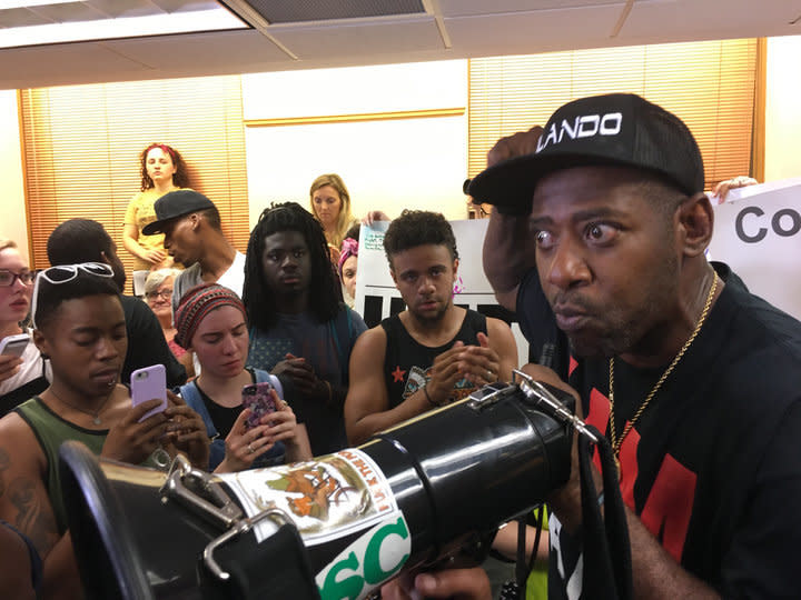 John Thompson addresses protesters after the crowd overtook&nbsp;Mayor Betsy Hodges' press conference on Friday. (Photo: Hayley Miller/HuffPost)