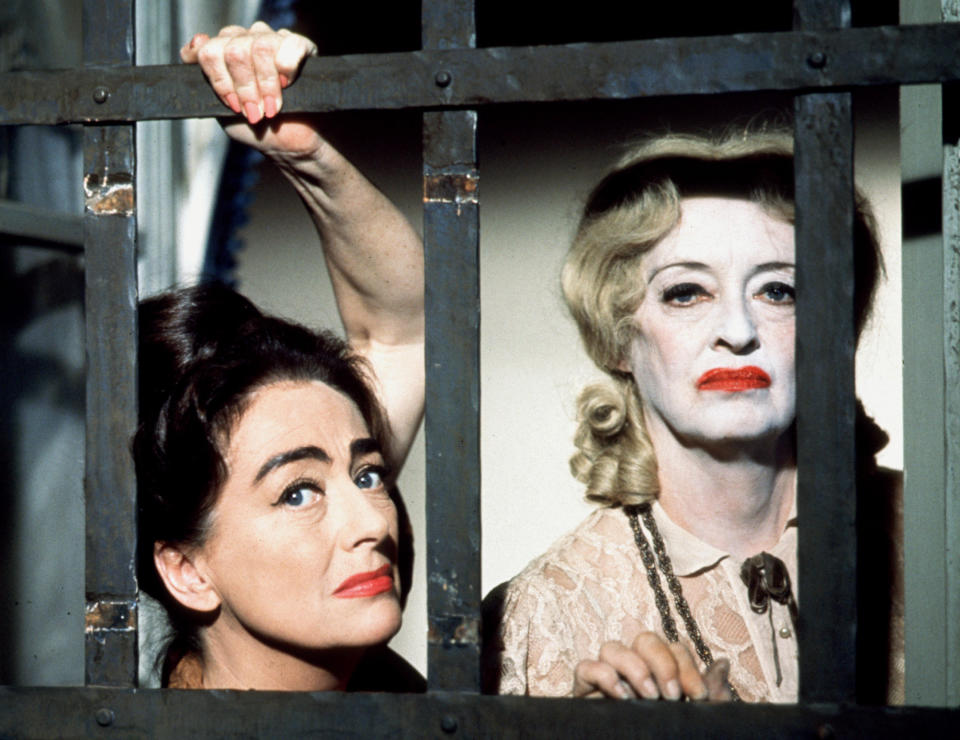 Bette Davis and Joan Crawford look through bars in "What Ever Happened To Baby Jane?"
