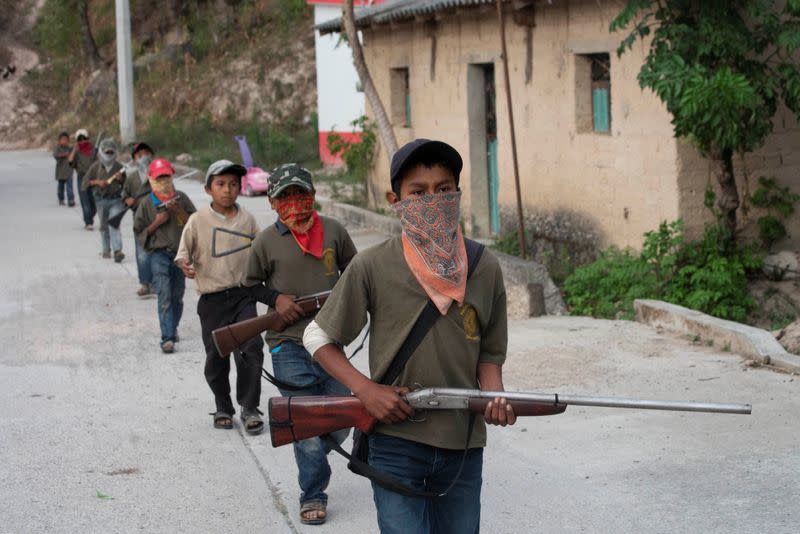 The Wider Image: "Under siege": Inside Mexican village where children are armed