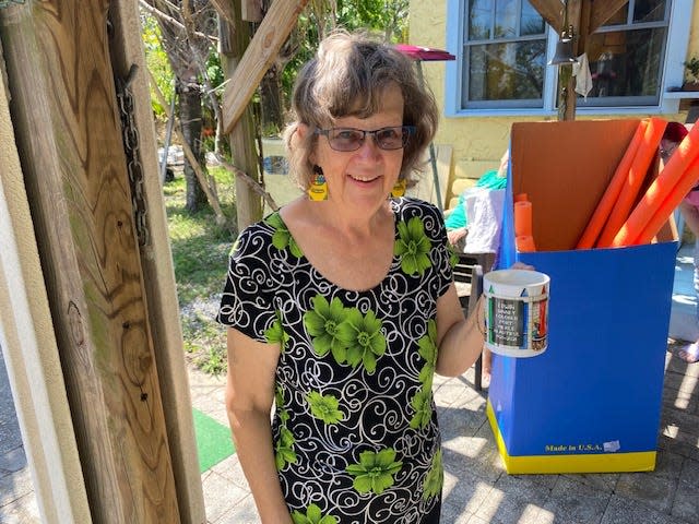 Jeanne Johansen, a local historian and president of the Fort Pierce Art Club, shows off Crayon-themed earrings and a coffee mug ahead of a March 30 event honoring Crayon inventor Edwin Binney, who lived in the community nearly a century ago.