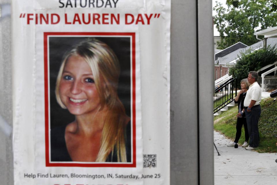 Charlene and Robert Spierer speak to reporters near a poster alerting people to their missing daughter, Lauren, in Bloomington, Ind. on Aug. 15, 2011