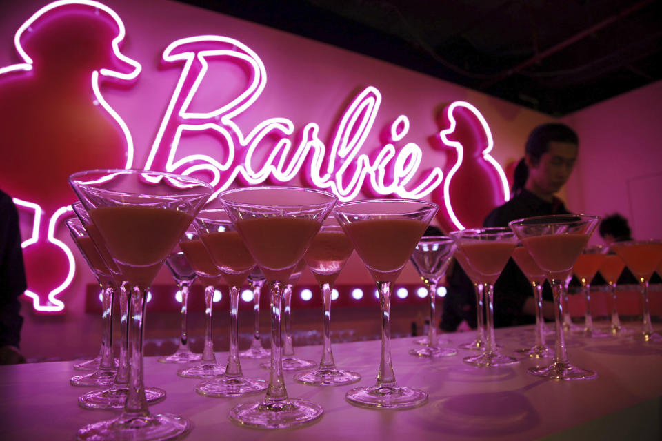 FILE - Barbie cocktails are prepared for guests at the opening ceremony of Barbie Shanghai flagship store, March 6, 2009, in Shanghai, China. The color pink has long been associated with the Barbie brand — she even has her own Pantone color. (AP Photo/Eugene Hoshiko, File)