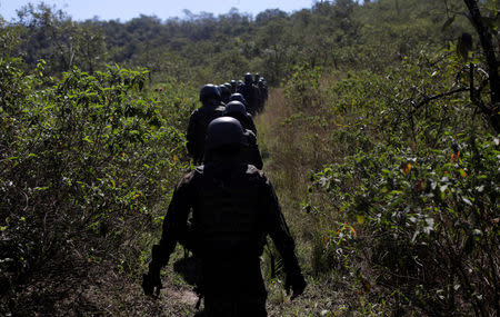 Brazilian Army soldiers patrol during an operation against drug gangs in Alemao slums complex in Rio de Janeiro, Brazil August 20, 2018. REUTERS/Ricardo Moraes