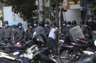 A man gestures while talking to police during a crackdown on anti-coup protesters holding a rally in front of the Myanmar Economic Bank in Mandalay, Myanmar on Monday, Feb. 15, 2021. Security forces in Myanmar intensified their crackdown against anti-coup protesters on Monday, seeking to quell the large-scale demonstrations calling for the military junta that seized power earlier this month to reinstate the elected government. (AP Photo)