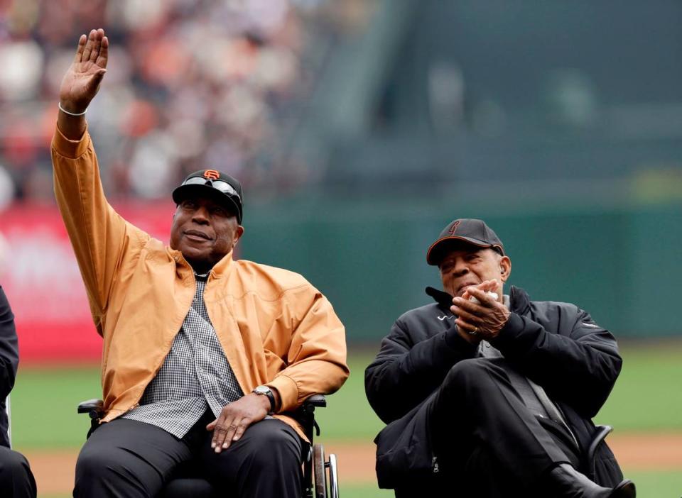 Former San Francisco Giants player Willie McCovey and Willie Mays during a ceremony to award Buster Posey the National League MVP trophy before a baseball game against the St. Louis Cardinals on Saturday, April 6, 2013 in San Francisco. (AP Photo/Marcio Jose Sanchez)