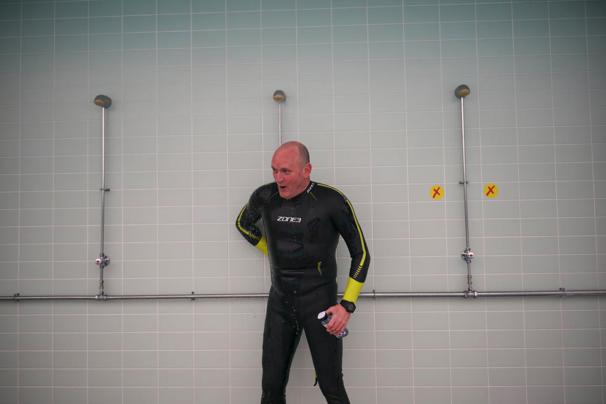 A swimmer takes a shower after exercising in the water at Hillingdon Lido in Uxbridge, west London, on the first day of a major easing of England's coronavirus lockdown to allow far greater freedom outdoors. Picture date: Monday March 29, 2021.