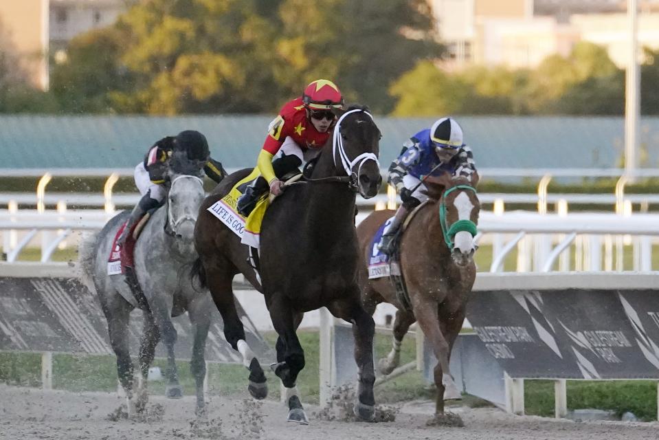 Life is Good and jockey Irad Ortiz Jr., lead Knicks Go and jockey Joel Rosario, left, and Stiletto Boy and Jose Ortiz, right, heading to the finish line during the Pegasus World Cup Saturday at Gulfstream Park.