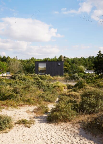 The cube-shaped structure, designed by architects Jean-Baptiste Barache and Sihem Lamine of Paris firm Arba, is clad in timber finished with pine tar.