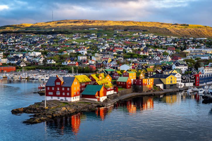 sunrise scene of capital city torshavn in faroe islands in north atlantic urban scene of scandinavian city in warm golden sunlight