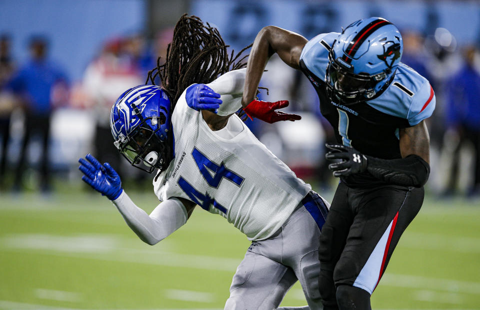 St. Louis Battlehawks safety Joe Powell (44) and Dallas Renegades wide receiver Jazz Ferguson (1) collide during an XFL football game. (AP Photo/Brandon Wade)