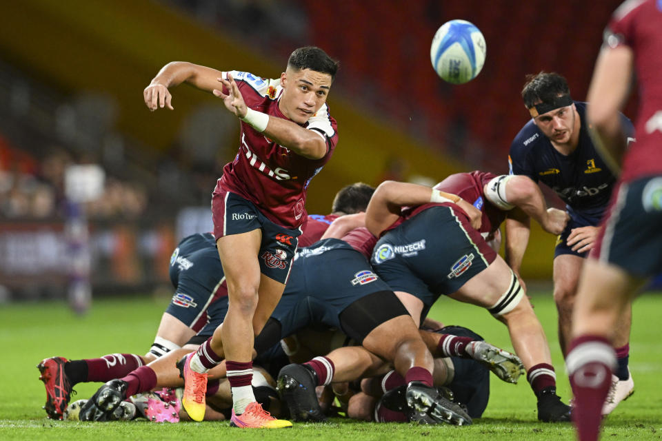 Kalani Thomas of the Queensland Reds passes the ball during their Super Rugby Pacific game against the Highlanders at Suncorp Stadium in Brisbane, Australia, Friday, April 19, 2024. (Darren England/AAP Image via AP)