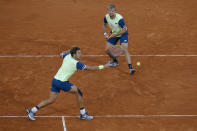 Kevin Krawietz, right, and Andreas Mies of Germany play a shot against Croatia's Mate Pavic and Brazil's Bruno Soares in the men's doubles final match of the French Open tennis tournament at the Roland Garros stadium in Paris, France, Saturday, Oct. 10, 2020. (AP Photo/Michel Euler)