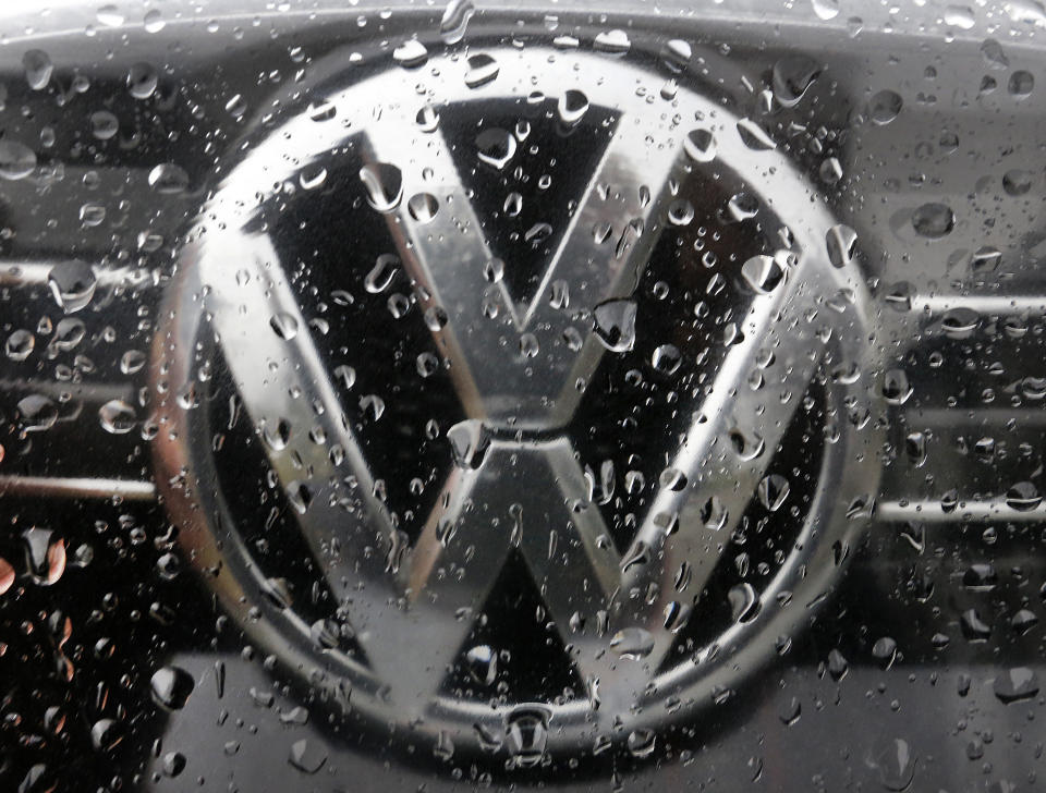 FILE - In this Friday, Nov. 18, 2016 file photo the Volkswagen logo is photographed through rain drops on a window in Frankfurt, Germany. Germany's Federal Court has ruled Volkswagen must buy back cars from owners who bought vehicles rigged to cheat in emissions tests but consumers must accept current value taking into account the mileage they drove rather than the full purchase price. (AP Photo/Michael Probst, file)