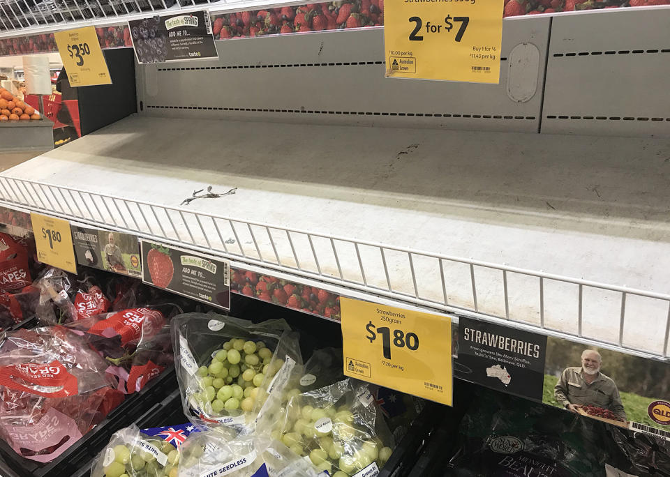 Empty shelves, normally stocked with strawberry punnets, are seen at a Coles Supermarket in Brisbane on Friday. Source: AAP