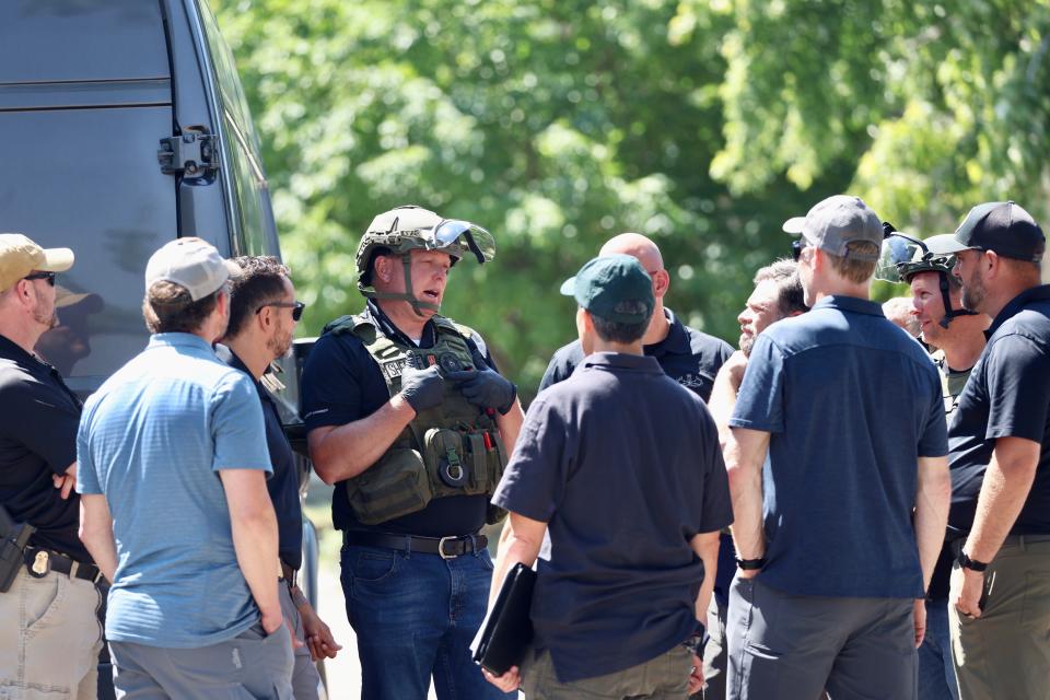 Law enforcement investigate at the scene of a shooting in Provo involving the FBI.